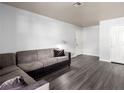Open-concept living area with light gray floors, neutral walls, and comfortable gray sectional sofa at 2451 N Rainbow Blvd # 1016, Las Vegas, NV 89108