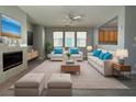 Bright living room featuring a fireplace, neutral tones, and modern furniture at 258 Bella Matese Ave, Las Vegas, NV 89183