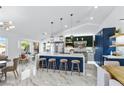 Spacious kitchen featuring a large center island, stylish pendant lights, and stainless steel appliances at 2652 Golfside Dr, Las Vegas, NV 89134