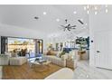 Open floor plan with marble floors leading to the living room, outdoor dining and kitchen with island seating at 2652 Golfside Dr, Las Vegas, NV 89134