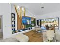 Bright living room features a large screen TV, custom shelving, and expansive glass doors to the exterior at 2652 Golfside Dr, Las Vegas, NV 89134