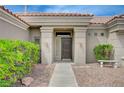 Inviting front entrance with a stone walkway, desert landscaping and a charming bench at 2721 Faiss Dr, Las Vegas, NV 89134