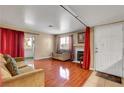 Comfortable living room with wood flooring, bright window, and a fireplace at 2725 S Nellis Blvd # 1052, Las Vegas, NV 89121