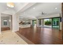 Expansive living area with an open layout, hardwood floors, and a seamless transition to the outdoor living space at 28 Tea Olive Dr, Las Vegas, NV 89141