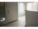 Entryway of home with tile flooring, white walls, and bar area with natural light at 3041 Casey Dr # 101, Las Vegas, NV 89120