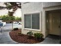 A condo with light beige exterior, manicured landscaping, and parking in the back at 3041 Casey Dr # 101, Las Vegas, NV 89120