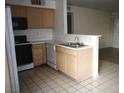 A well lit kitchen with white cabinets and black appliances at 3041 Casey Dr # 101, Las Vegas, NV 89120