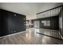Spacious living room with wood floors, unique divider, and view into the modern kitchen at 3409 Catherine Mermet Ave, North Las Vegas, NV 89081