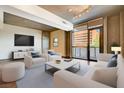 Bright living room with a large window view, hardwood floors, and neutral-toned furniture at 353 E Bonneville Ave # 181/281, Las Vegas, NV 89101