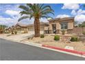 A view of the house with a well-manicured front yard featuring desert landscaping and a two-car garage at 4624 Ventana Rey St, North Las Vegas, NV 89081
