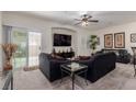 Inviting living room with plush seating, ceiling fan, and sliding glass door at 4808 Straight Flush Dr # 103, Las Vegas, NV 89122