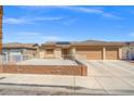 Charming single-story house boasts a two-car garage, desert landscaping and inviting curb appeal at 5224 Red Vine St, North Las Vegas, NV 89031
