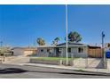 Inviting single-story home featuring a freshly painted exterior and gated front yard at 5409 Holmby Ave, Las Vegas, NV 89146