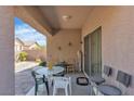 Cozy covered patio with table and chairs, perfect for outdoor dining and relaxation at 6160 Majestic Wind Ave, Las Vegas, NV 89122