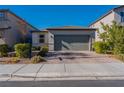 Charming single-story home with a well-manicured lawn, desert landscaping, and a two-car garage at 6317 Highledge St, North Las Vegas, NV 89081