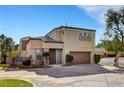 Two-story home with a two-car garage, desert landscaping, and a well-maintained lawn at 644 Chase Tree St, Las Vegas, NV 89144
