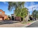 Desert home with a two-car garage, mature trees, and front yard landscaping at 644 Chase Tree St, Las Vegas, NV 89144