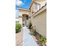 Charming front entrance with a walkway lined with colorful flowerbeds and a cozy bench for relaxing at 6440 High Sierra Ave, Las Vegas, NV 89156