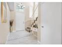 Inviting foyer with tile flooring, staircase, decorative chandelier, and ample natural light at 6440 High Sierra Ave, Las Vegas, NV 89156