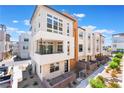 Modern townhouse with a balcony, landscaped front yard, and contemporary design in a residential community at 647 Spotted Falcon St, Las Vegas, NV 89138
