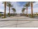Scenic community park featuring a central water fountain and inviting walkways lined with palm trees and benches at 6804 Sage Gold Ct, North Las Vegas, NV 89086