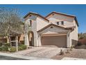 Charming stucco home with two-car garage and brick paver driveway at 7060 Seat Wall Rd, Las Vegas, NV 89148