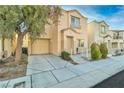 Well-manicured two-story home with a tidy lawn, attached garage, and quaint front porch at 7632 Calico Fields St, Las Vegas, NV 89149