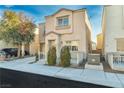 Inviting two-story home with landscaped front yard, an attached garage, and a cozy entrance at 7632 Calico Fields St, Las Vegas, NV 89149