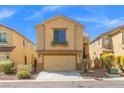 Charming tan home featuring a two-car garage and pleasant curb appeal at 8453 Cheerful Brook Ave, Las Vegas, NV 89143