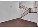 Bright entryway boasts high ceilings, a staircase with wood railing, and rich dark wood flooring at 8716 Brilliant Star Dr, Las Vegas, NV 89178