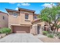 Charming two-story home featuring a well-manicured yard and a welcoming front entrance with stone details at 8716 Brilliant Star Dr, Las Vegas, NV 89178
