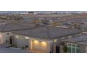 Aerial view of a modern home featuring an attached two car garage and neighborhood views at 916 Belleforte Ln, Las Vegas, NV 89138