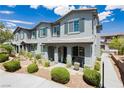 Charming two-story townhome with stucco exterior, landscaped front yard, covered porch, and inviting curb appeal at 965 Nevada State Dr # 35101, Henderson, NV 89002