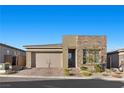 Beautiful one-story home featuring a two-car garage, stone accents, and desert landscaping at 12476 Heritage Bend Dr, Las Vegas, NV 89138