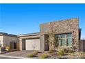 Charming one-story home featuring a two-car garage, stone accents, and well-maintained landscaping at 12476 Heritage Bend Dr, Las Vegas, NV 89138