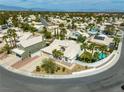 A beautiful aerial view of the home and the surrounding neighborhood, complete with palm trees and desert landscaping at 2212 Marble Gorge Dr, Las Vegas, NV 89117