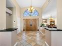 Grand foyer features soaring ceilings, tile floors, large arched window, and decorative, double-door entry at 2212 Marble Gorge Dr, Las Vegas, NV 89117