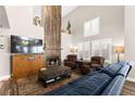 Comfortable living room featuring a fireplace, vaulted ceiling, plush seating, and natural light at 5492 Royal Vista Ln, Las Vegas, NV 89149
