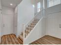 Bright entryway with wood laminate flooring and a stairway leading to the upper level at 6267 Dollar Bill Ct, Las Vegas, NV 89141