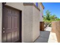 Home's private entrance with a secure brown door and textured stucco exterior at 6267 Dollar Bill Ct, Las Vegas, NV 89141