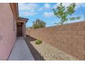 Home exterior featuring a gated side entrance and brick perimeter wall for added privacy at 703 Shiva St, Las Vegas, NV 89178
