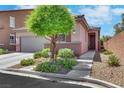 Inviting single-story home with mature tree, front yard landscaping, and welcoming entryway at 703 Shiva St, Las Vegas, NV 89178