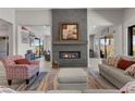 A cozy living room features a fireplace, comfortable seating, and plenty of natural light at 7477 Triple Knot Ct, Las Vegas, NV 89113