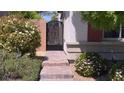 Beautiful walkway leading to an ornate gate and the main entrance with flowering bushes at 7788 Ebro Valley Ct, Las Vegas, NV 89113