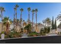 Striking exterior of this home showcasing manicured landscaping and tall palm trees at 8109 Moonstone Cir, Las Vegas, NV 89128
