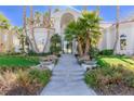 Inviting front entrance featuring a manicured lawn and grand staircase at 8109 Moonstone Cir, Las Vegas, NV 89128