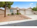 Charming single-story home with a two-car garage, desert landscaping, and a tile roof at 9539 Iris Flat Ct, Las Vegas, NV 89178