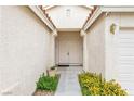 Inviting entryway with a double door, plants, and a decorative light fixture at 9539 Iris Flat Ct, Las Vegas, NV 89178