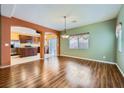 Open-concept dining area with hardwood flooring adjacent to the kitchen at 9651 Bouncing Ball St, Las Vegas, NV 89178