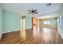 Spacious living room with hardwood floors, fan and neutral paint scheme at 9651 Bouncing Ball St, Las Vegas, NV 89178